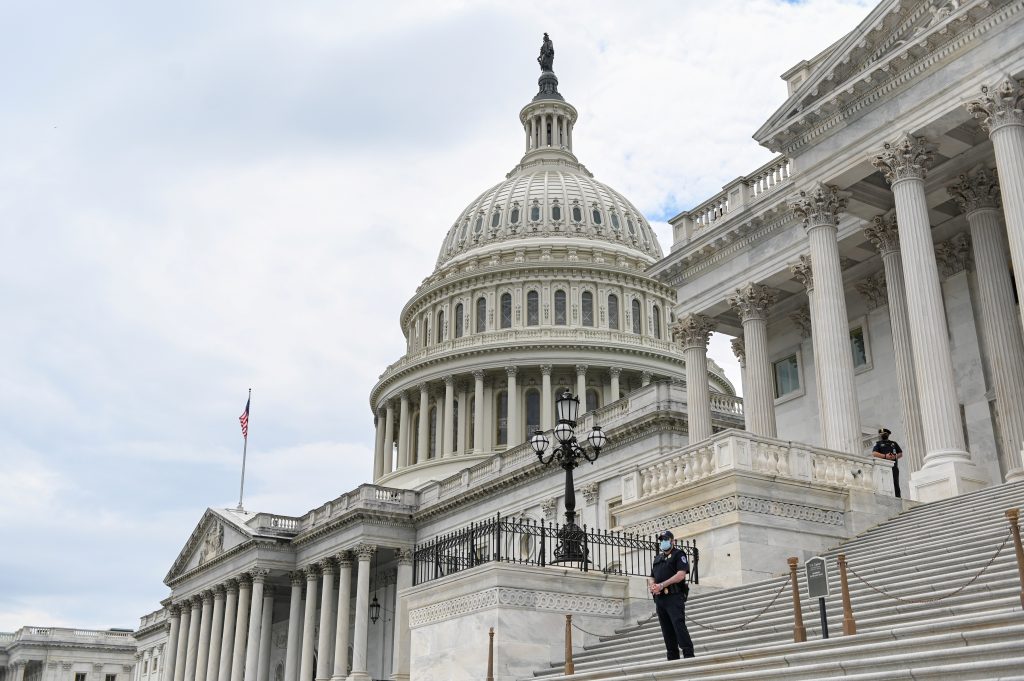 Police officers wearing face masks guard the U.S. Capitol Building in Washington