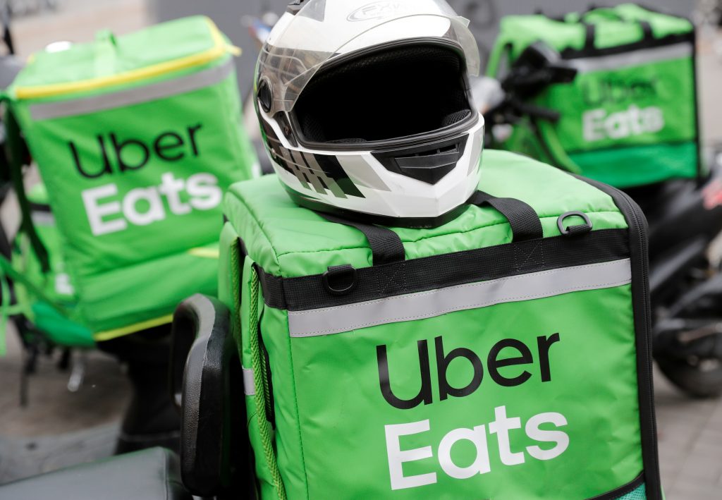 FILE PHOTO: Delivery bags with logos of Uber Eats are seen on a street in central Kiev