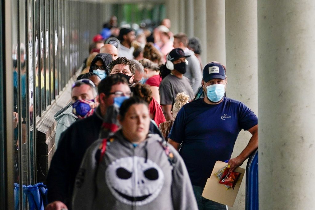 FILE PHOTO: Hundreds of people line up outside a Kentucky Career Center hoping to find assistance with their unemployment claim in Frankfort
