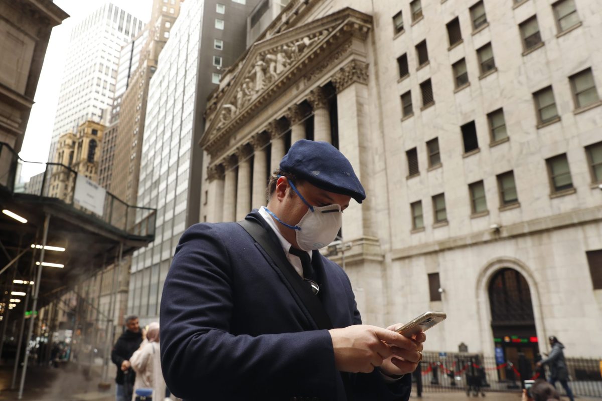 A man wears a protective mask as he walks on Wall Street during the coronavirus outbreak in New York