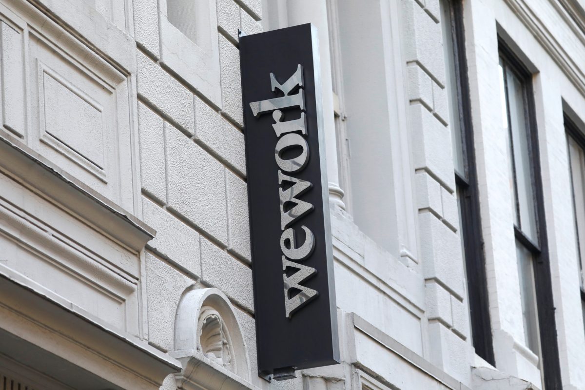 A sign is seen above the entrance to the WeWork corporate headquarters in Manhattan, New York