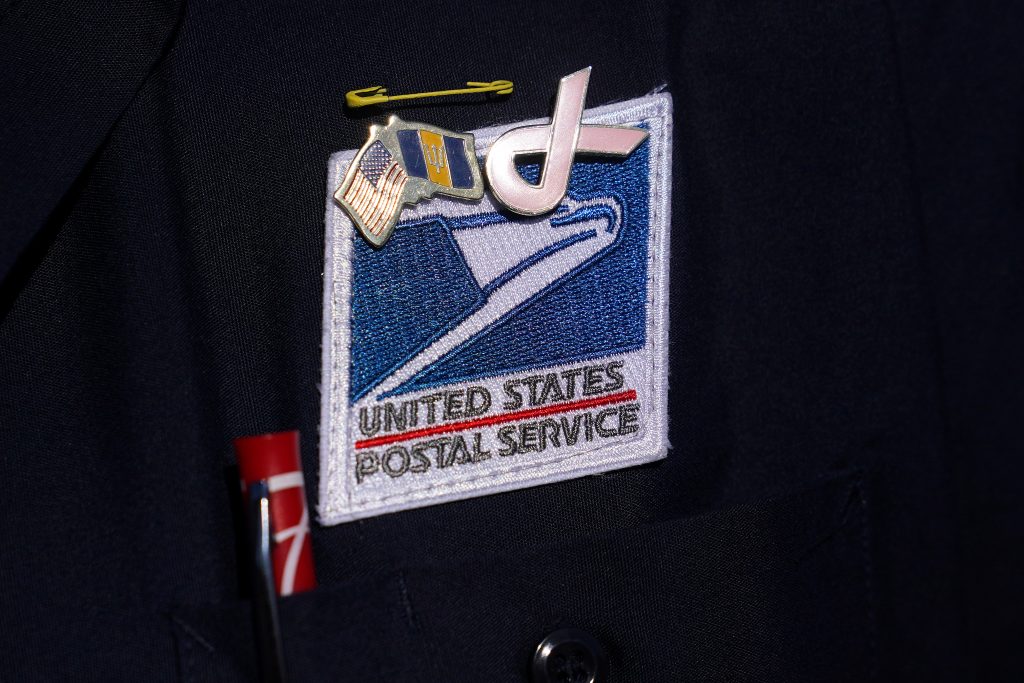 USPS badge is pictured during a news conference about the postal service in New York City