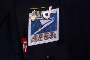 USPS badge is pictured during a news conference about the postal service in New York City