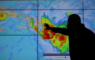 FILE PHOTO: A member of the Emergency Operations Committee (COE) monitors the trajectory of Storm Laura in Santo Domingo