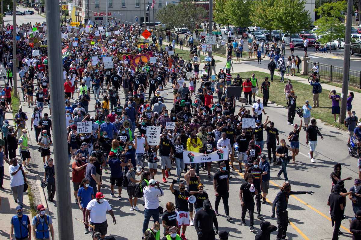 People protest after a Black man identified as Jacob Blake was shot several times by police in Kenosha