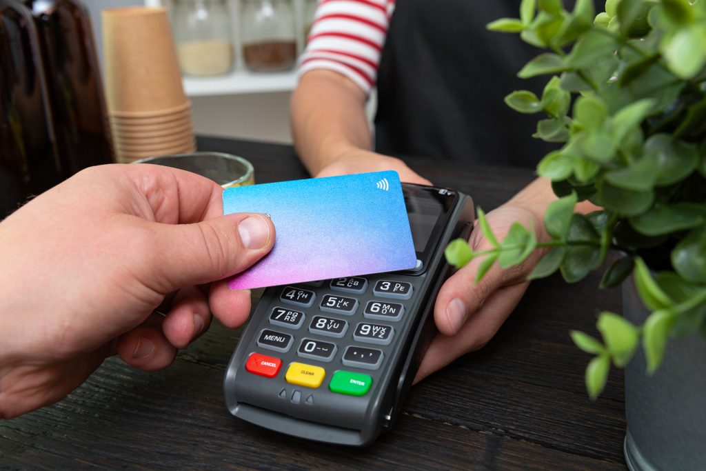 Customer making wireless or contactless payment using credit card