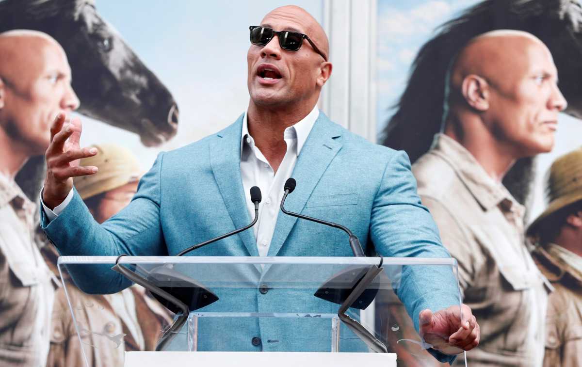 Actor Johnson speaks during a ceremony for actor Kevin Hart to place his handprints and footprints in cement in the forecourt of the TCL Chinese theatre in Los Angeles