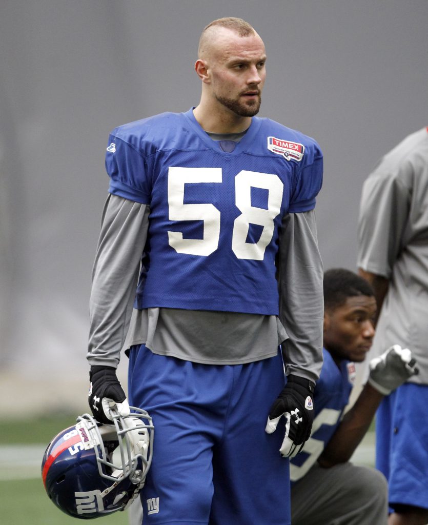 Giants linebacker Herzlich watches over practice for the NFL Super Bowl XLVI in Indianapolis