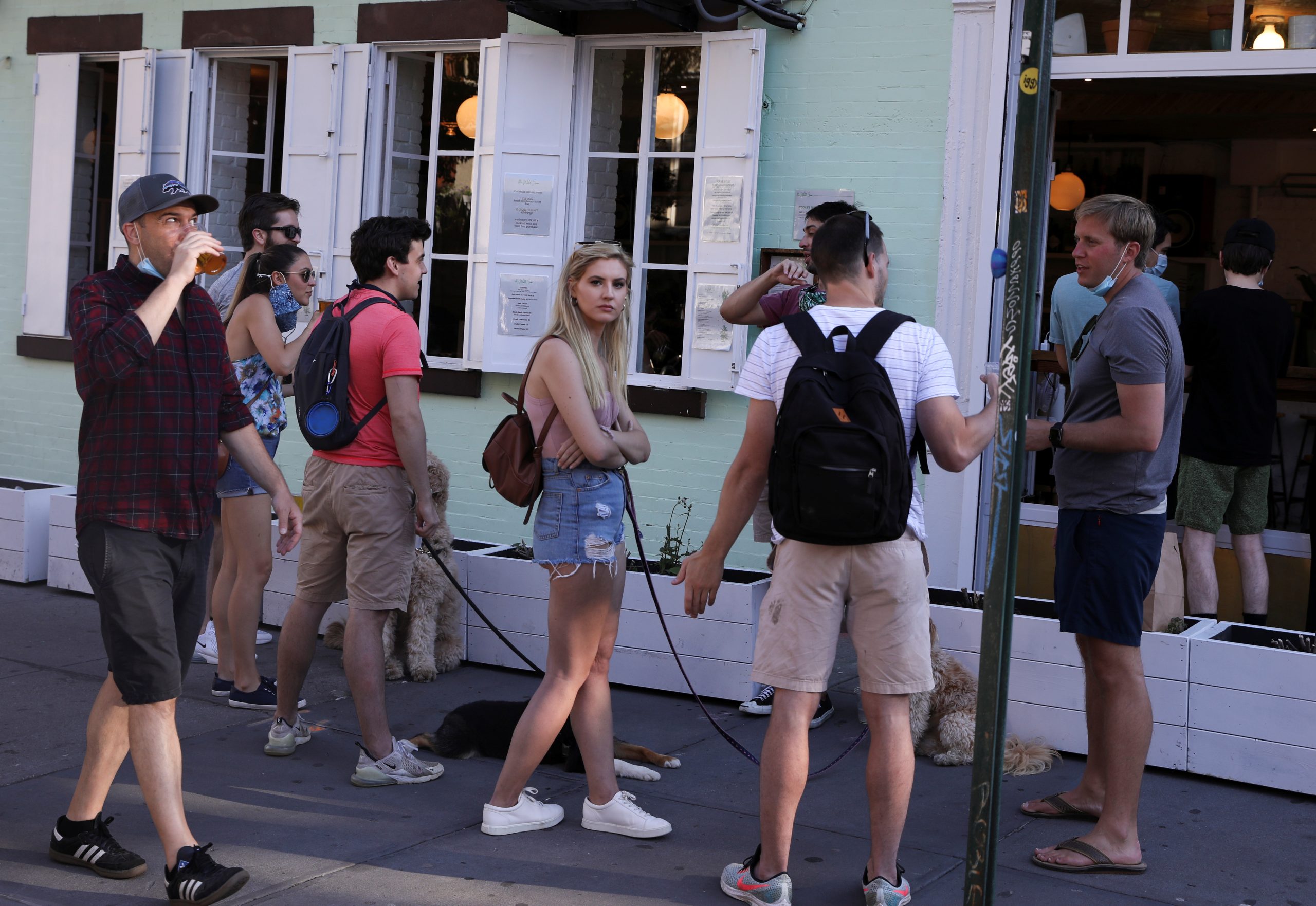 People drink outside a bar during the reopening phase following the coronavirus disease (COVID-19) outbreak