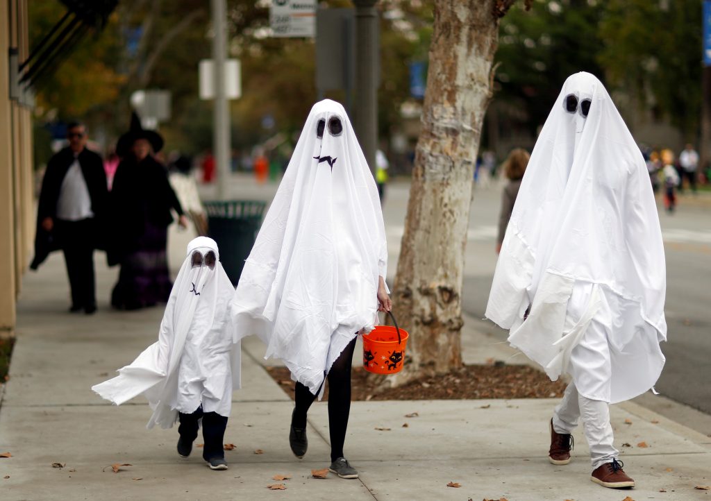 FILE PHOTO: People wearing costumes walk during Halloween in Sierra Madre
