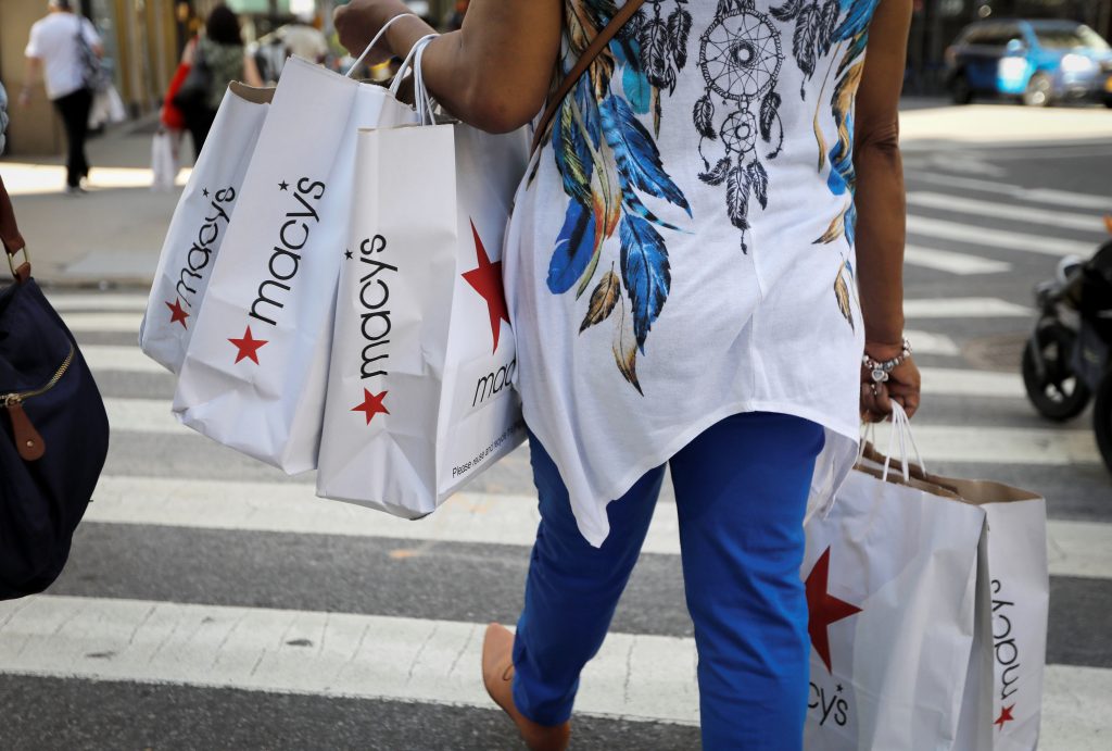 A woman carries shopping bags from Macy’s department store in midtown Manhattan in New York