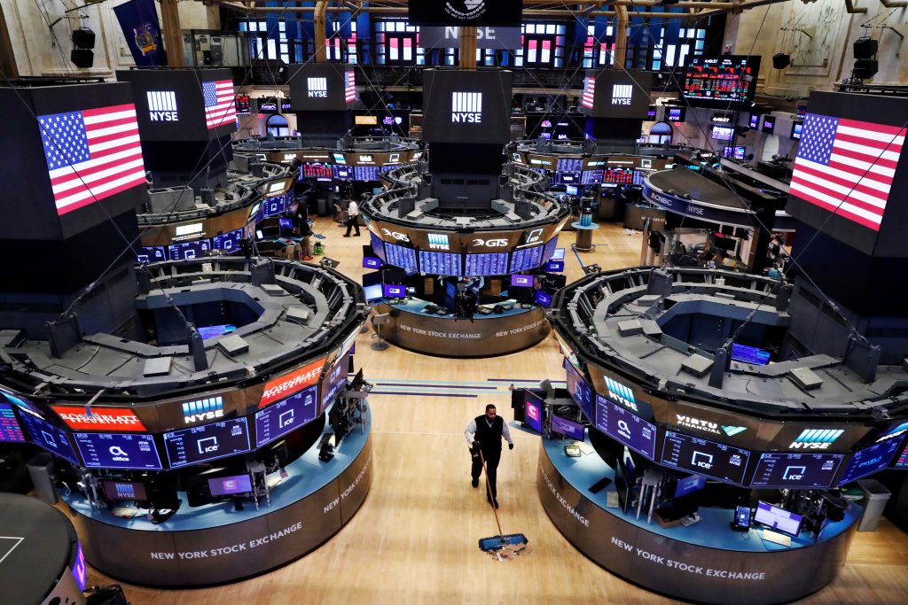 FILE PHOTO: A worker cleans the floor of the New York Stock Exchange (NYSE)