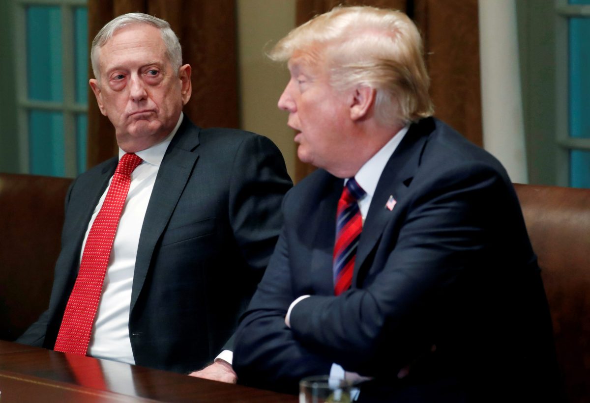 FILE PHOTO: U.S. Defense Secretary James Mattis listens as U.S. President Donald Trump speaks to the news media while gathering for a briefing from his senior military leaders in the Cabinet Room at the White House in Washington