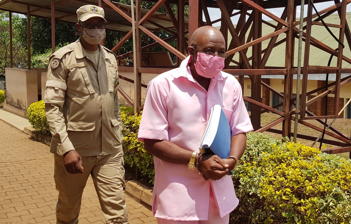 Paul Rusesabagina, portrayed as a hero in a Hollywood movie about Rwanda’s 1994 genocide, is escorted in handcuffs from the courtroom in Kigali