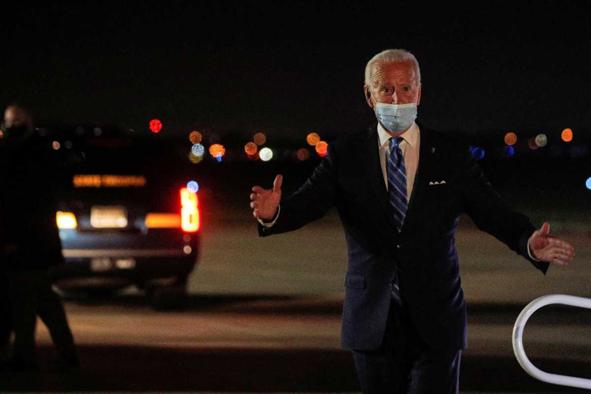 U.S. Democratic presidential candidate Joe Biden greets members of his staff and the press as he exits his campaign plane after campaigning in Miami