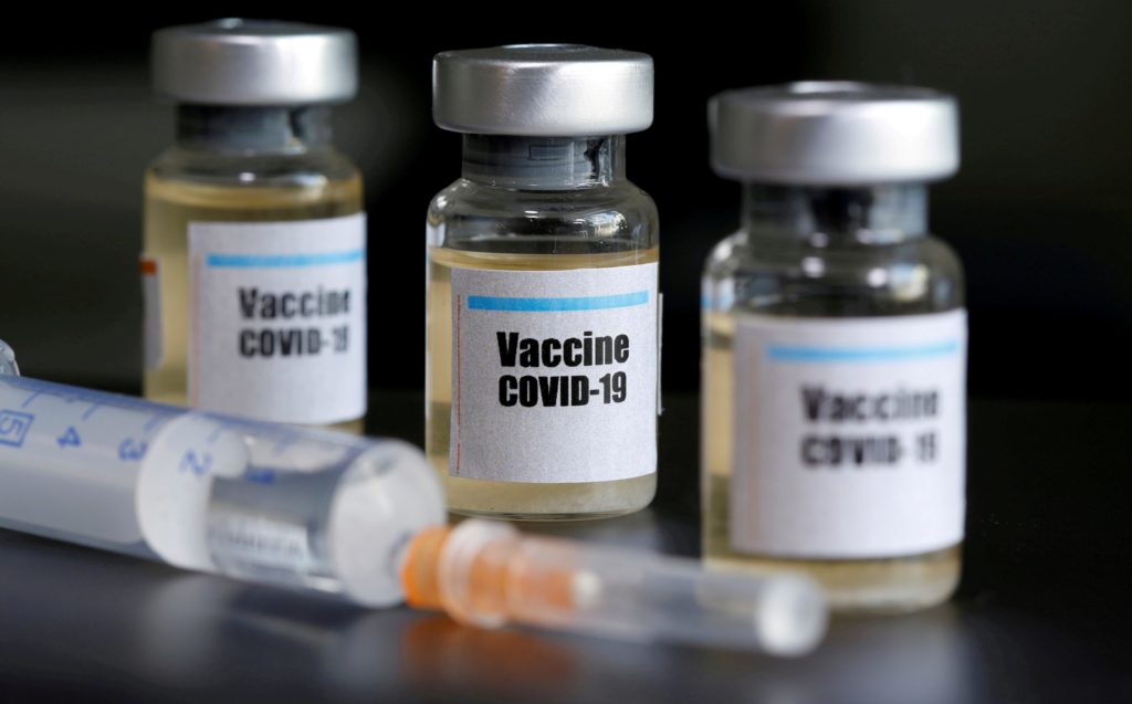 FILE PHOTO: Small bottles labeled with a “Vaccine COVID-19” sticker and a medical syringe are seen in this illustration