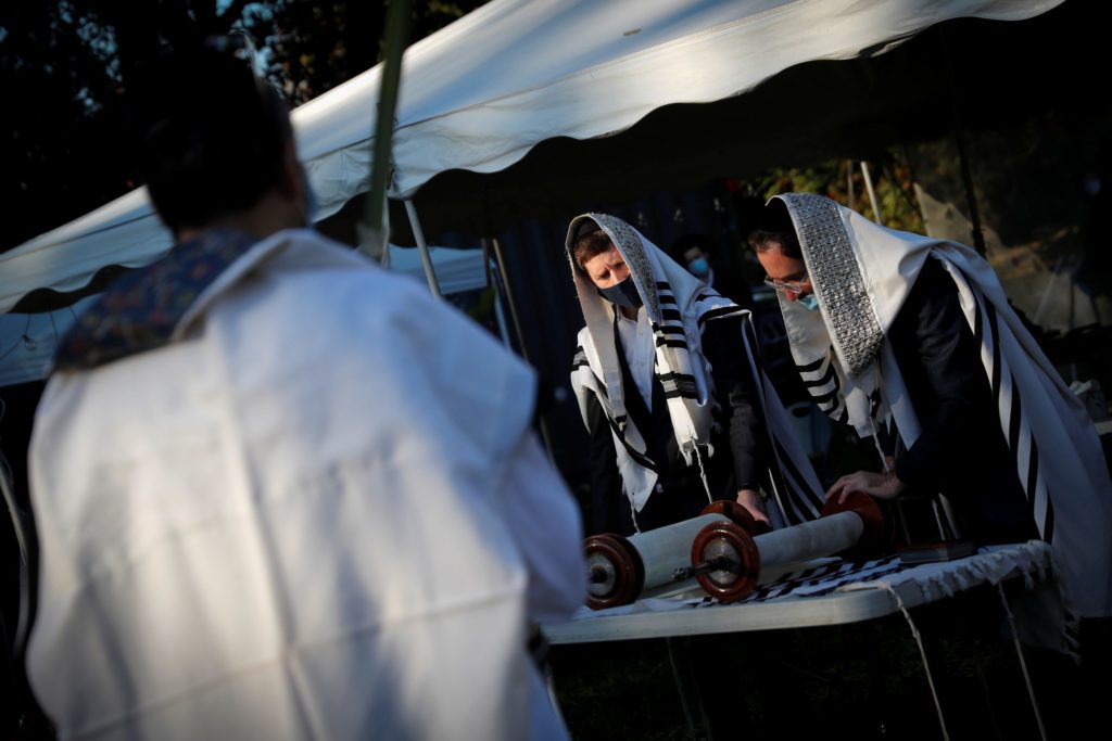 Orthodox Jews gather for “Hoshanot prayers” as part of their Sukkot observance on neighborhood lawn in Monsey New York