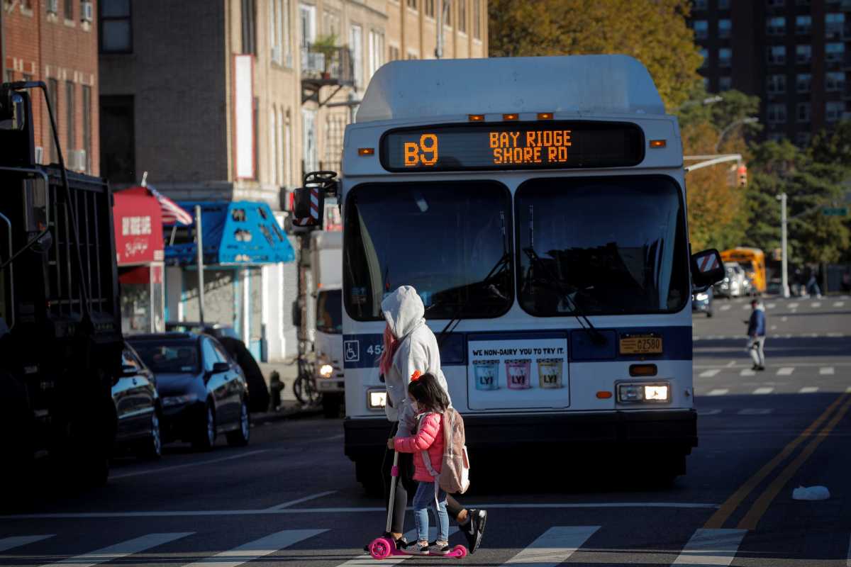 A woman walks her child to school during the outbreak of the coronavirus disease (COVID-19) in the Bay Ridge area of Brooklyn
