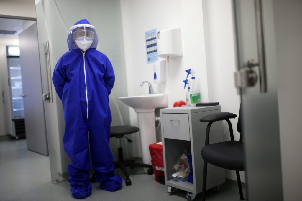 FILE PHOTO: A nurse wearing protective gear is seen inside a coronavirus disease (COVID-19) sampling room of the Synlab laboratory