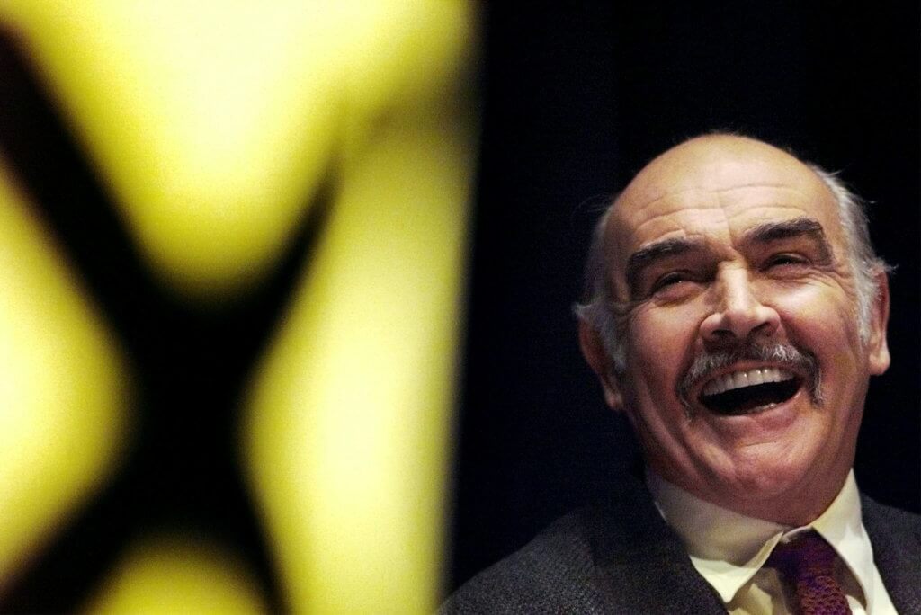 FILE PHOTO: Actor Sean Connery laughs as he listens to a speech by Alex Salmond at a Scottish National Party rally at the Edinburgh International conference centre
