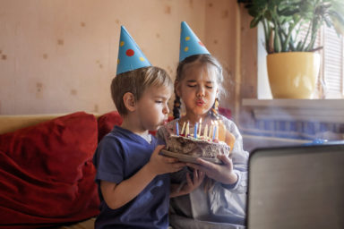 Happy father with two sibling celebrating birthday via internet in quarantine time