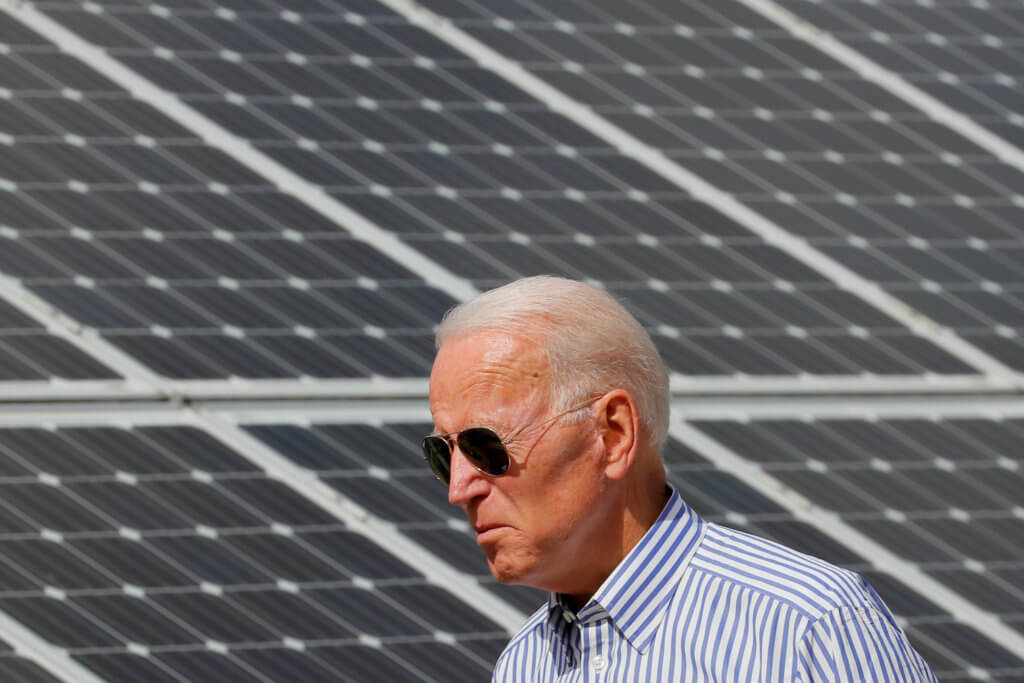 FILE PHOTO: Democratic 2020 U.S. presidential candidate Biden walks past solar panels in Plymouth