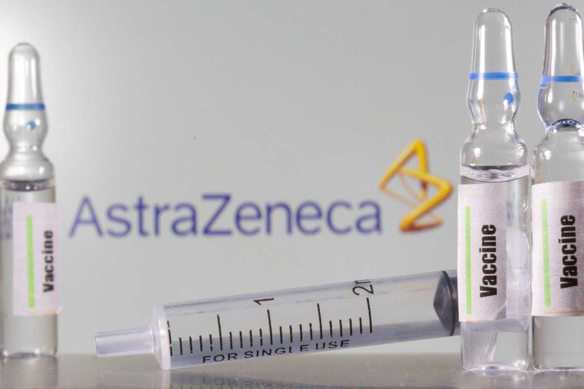 FILE PHOTO: A test tube labelled with the Vaccine is seen in front of AstraZeneca logo in this illustration taken