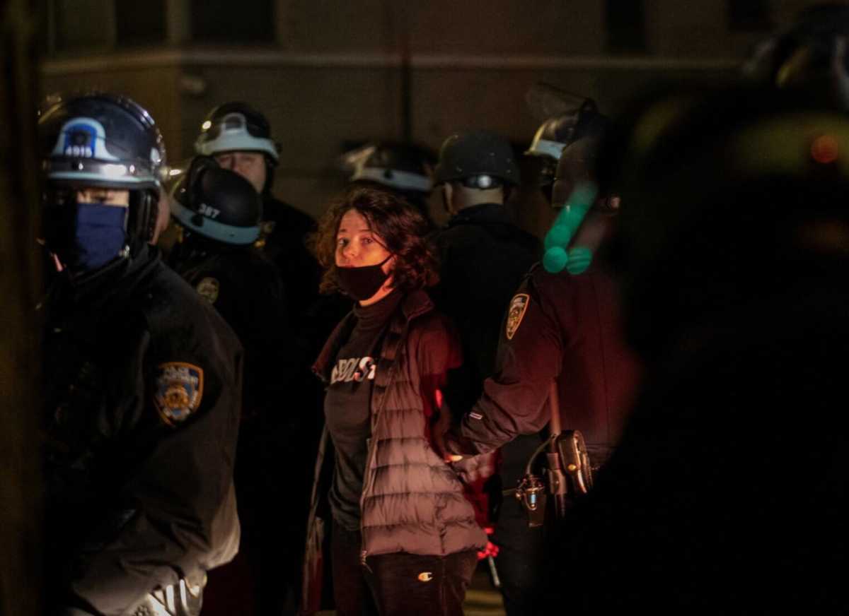 Police officers stand next to a detained demonstrator near Washington Square park the day after Election Day in Manhattan, New York City
