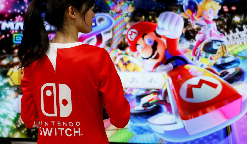 FILE PHOTO: An event employee of Nintendo attends the presentation ceremony for the Switch game console in 2017