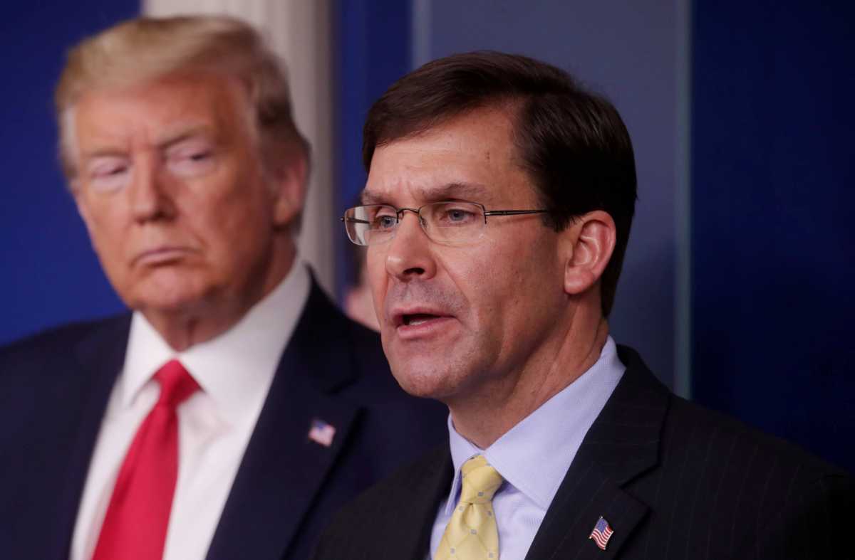 FILE PHOTO: U.S. President Trump listens to Secretary of Defense Mark Esper speak about coronavirus response at the White House in Washington