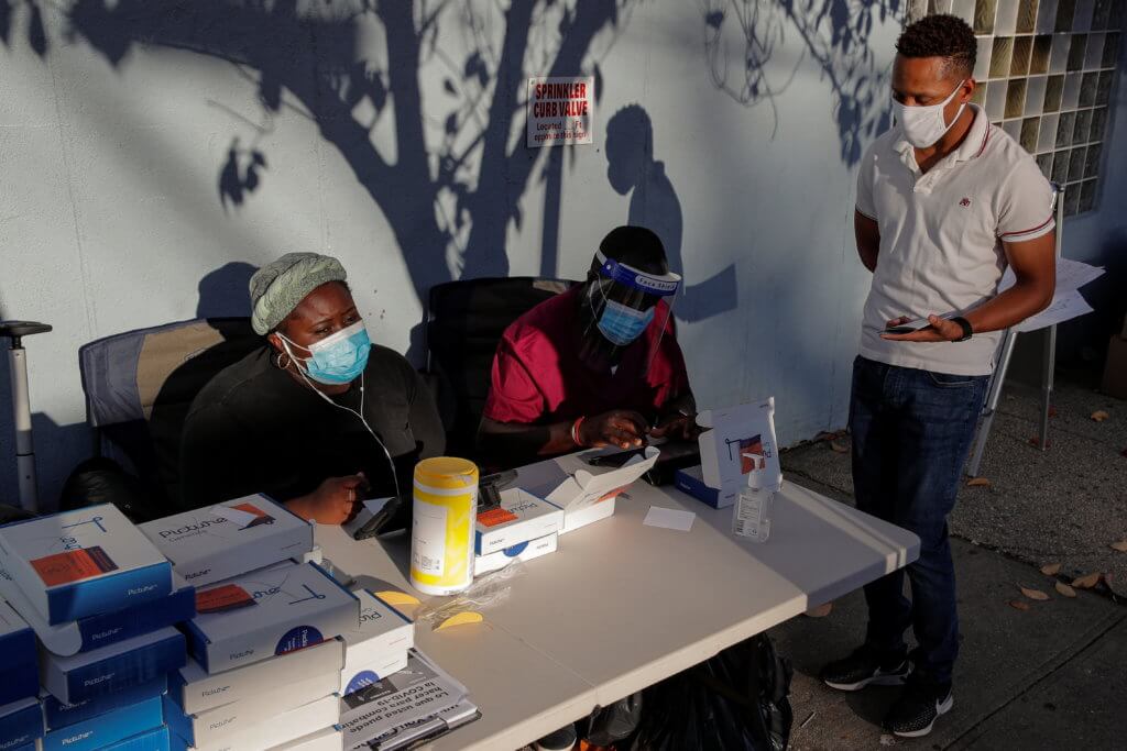 A man speaks to healthcare workers before taking a test for the coronavirus disease (COVID-19) in Staten Island, New York