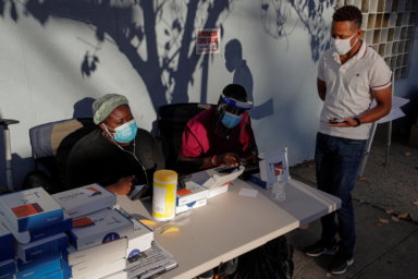 A man speaks to healthcare workers before taking a test for the coronavirus disease (COVID-19) in Staten Island, New York
