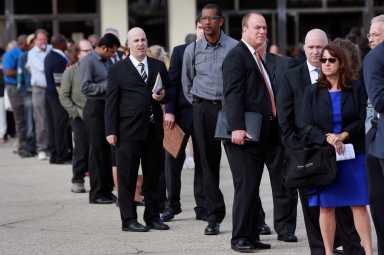 FILE PHOTO: People wait in line to enter the Nassau County Mega Job Fair at Nassau Veterans Memorial Coliseum in Uniondale, New York