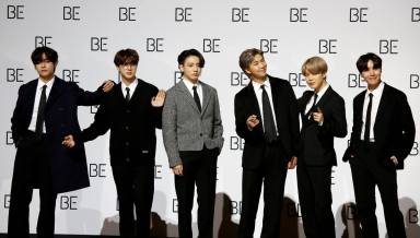FILE PHOTO: Members of K-pop boy band BTS pose for photographs during a news conference promoting their new album “BE(Deluxe Edition)” in Seoul