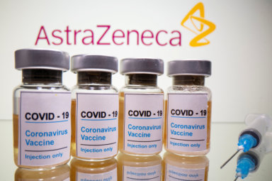 FILE PHOTO: Vials and medical syringe are seen in front of AstraZeneca logo in this illustration