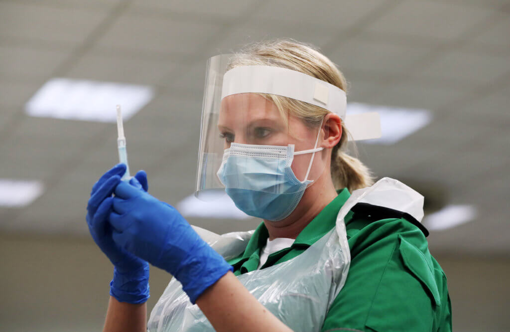 FILE PHOTO: A St John’s Ambulance volunteer holds a syringe during a coronavirus disease (COVID-19) vaccinator training course at the Princess Anne Training Centre in Derby