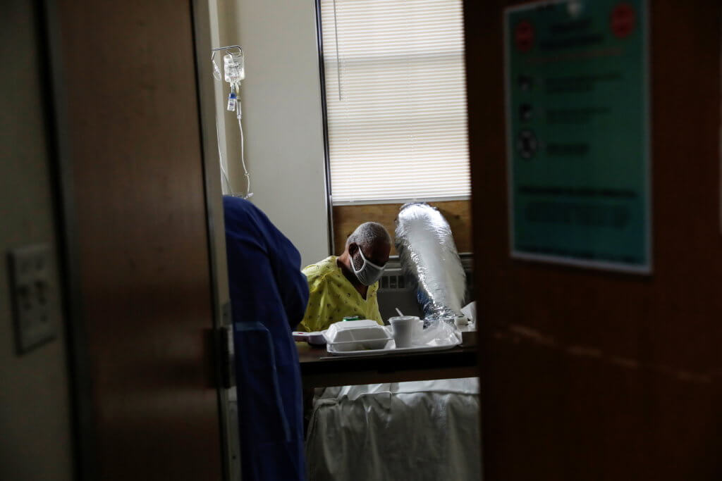 Andre Johnson, a coronavirus disease (COVID-19) positive patient, sits in his isolation room at Roseland Community Hospital on the South Side of Chicago, Illinois