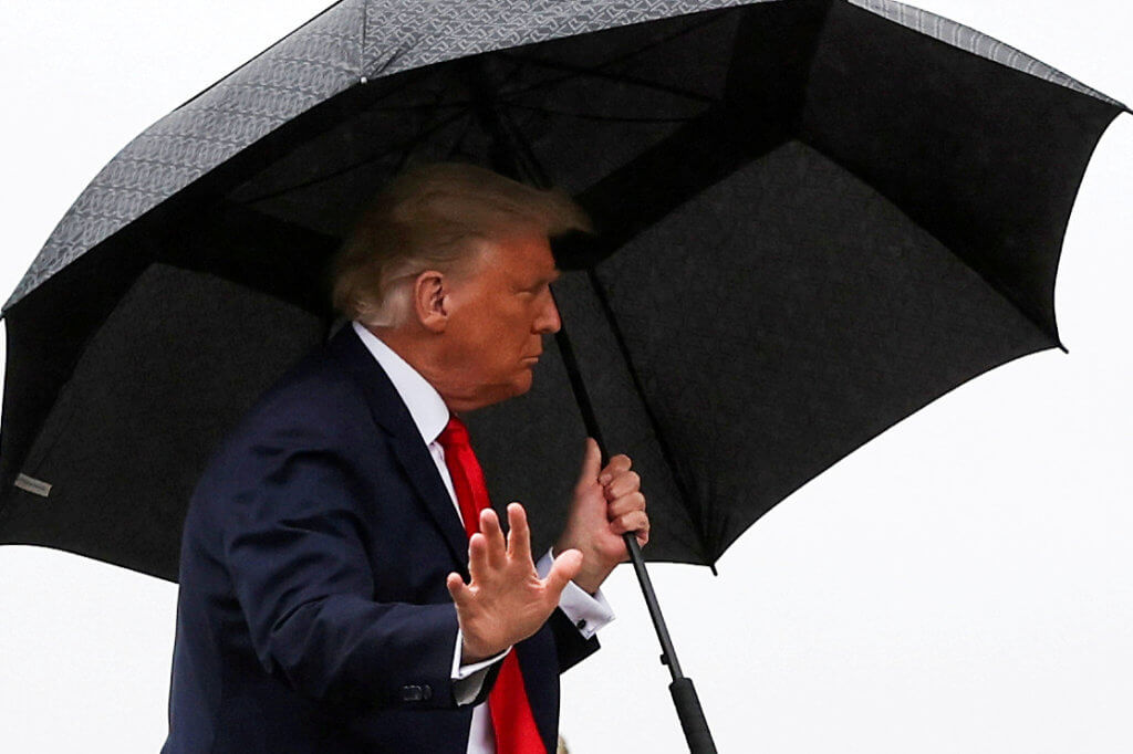 FILE PHOTO: U.S. President Donald Trump carries an umbrella while boarding Air Force One at Joint Base Andrews, Maryland
