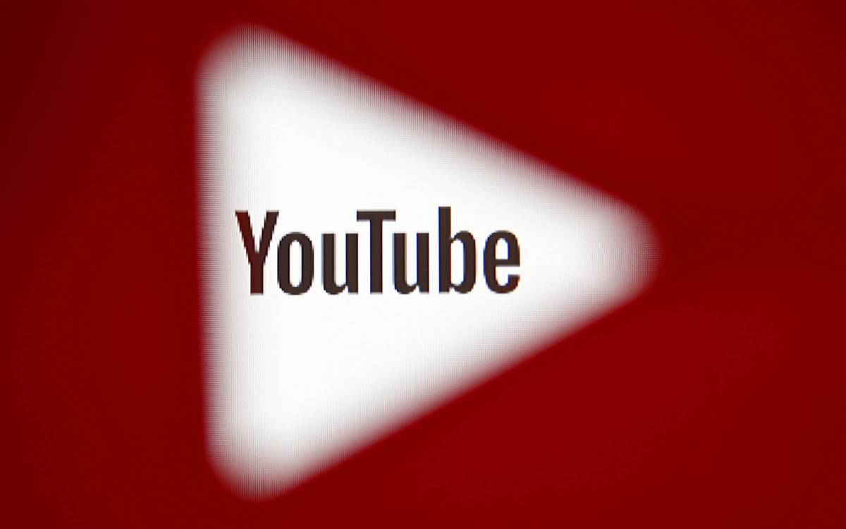 FILE PHOTO: A 3D-printed YouTube icon is seen in front of a displayed YouTube logo in this illustration
