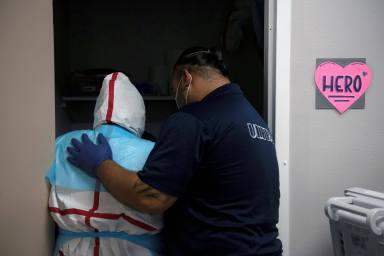FILE PHOTO: Healthcare personnel work inside a COVID-19 unit in Houston