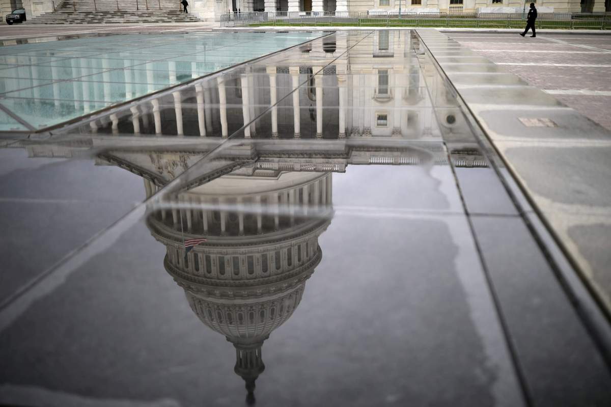 FILE PHOTO: The U.S. Capitol Building is reflected on a marble seating area following a rainstorm at the East Front on Capitol Hill in Washington
