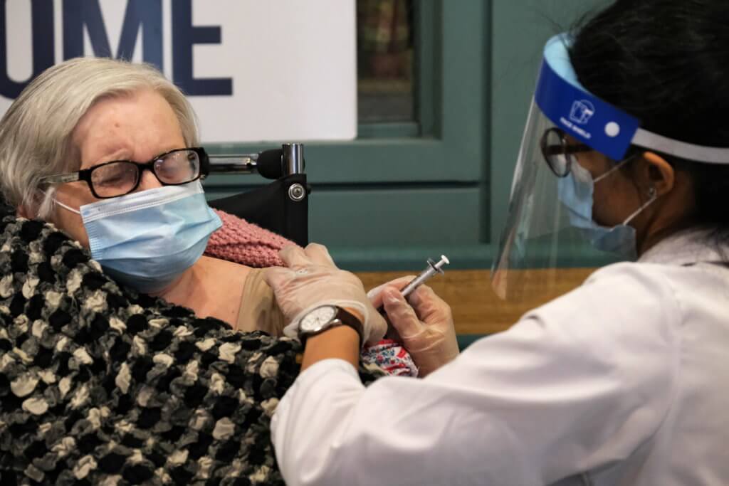 Stanislawa Cybulski, 82, a patient at The New Jewish Home, a nursing home facility, receives the coronavirus disease (COVID-19) vaccine from Walgreens Pharmacist Jessica Sahni in the Manhattan borough of New York City
