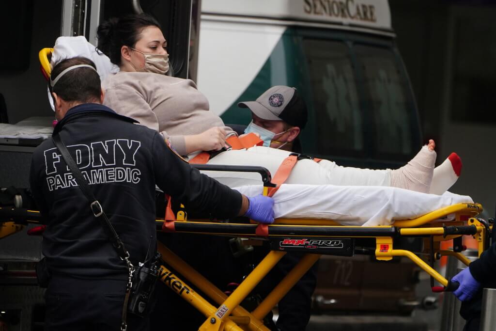 A woman is brought to a hospital on a stretcher in New York