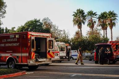 Firefighters and paramedics wait outside LAC + USC Medical Center during a surge of coronavirus disease (COVID-19) cases in Los Angeles