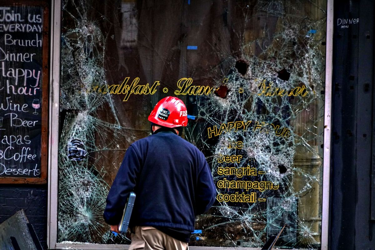'This corner is cursed!' East Village church fire the latest in heartbreaking tragedies 2 A firefighter examines the fractured windowpane of Café Mocha