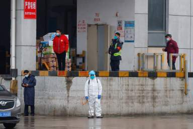 A worker in PPE stands in Baishazhou market during a visit of World Health Organization (WHO) team tasked with investigating the origins of the coronavirus (COVID-19) pandemic, in Wuhan