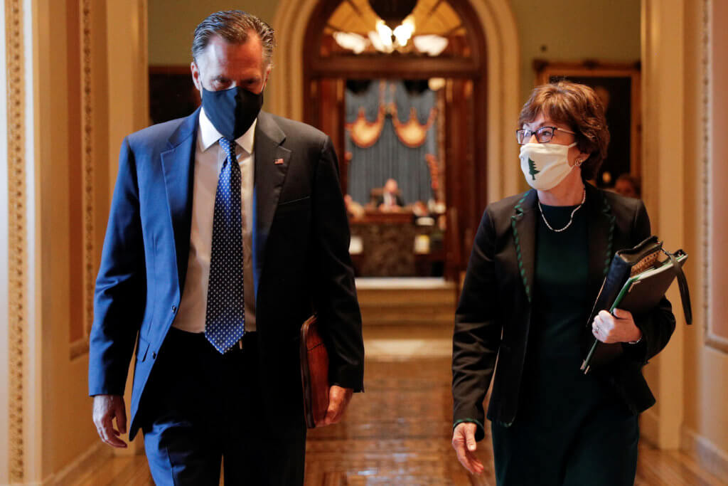 FILE PHOTO: Senators Romney and Collins walk to the office of the Majority Leader from the Senate Chamber ahead of a meeting with Majority Leader McConnell on Capitol Hill in Washington