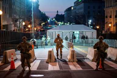 National Guard members get instructions as others stand guard near the White House ahead of U.S. President-elect Joe Biden’s inauguration, in Washington