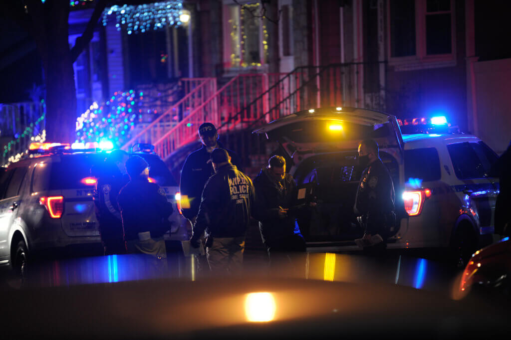 Officers probe a shooting on 55 Avenue and 64 Street. (Photo by Lloyd Mitchell)