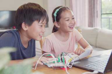 Mixed race young Asian children having fun learning coding together, learning remotely at home, STEM science, homeschooling education, Social distancing, isolation concept